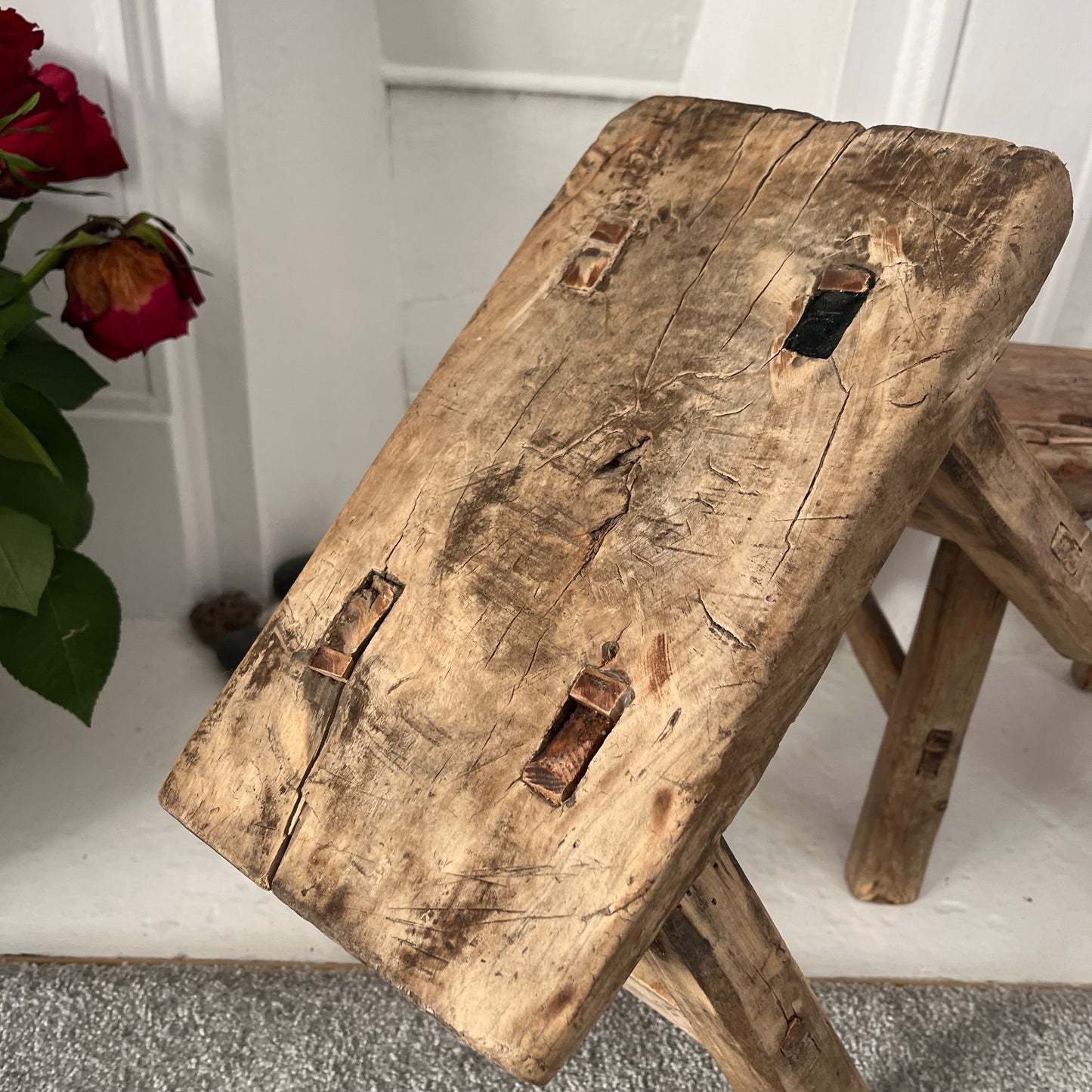 Rustic milking stools with a weathered finish, showcasing simple, sturdy design and vintage countryside charm, perfect for cozy, farmhouse-style decor