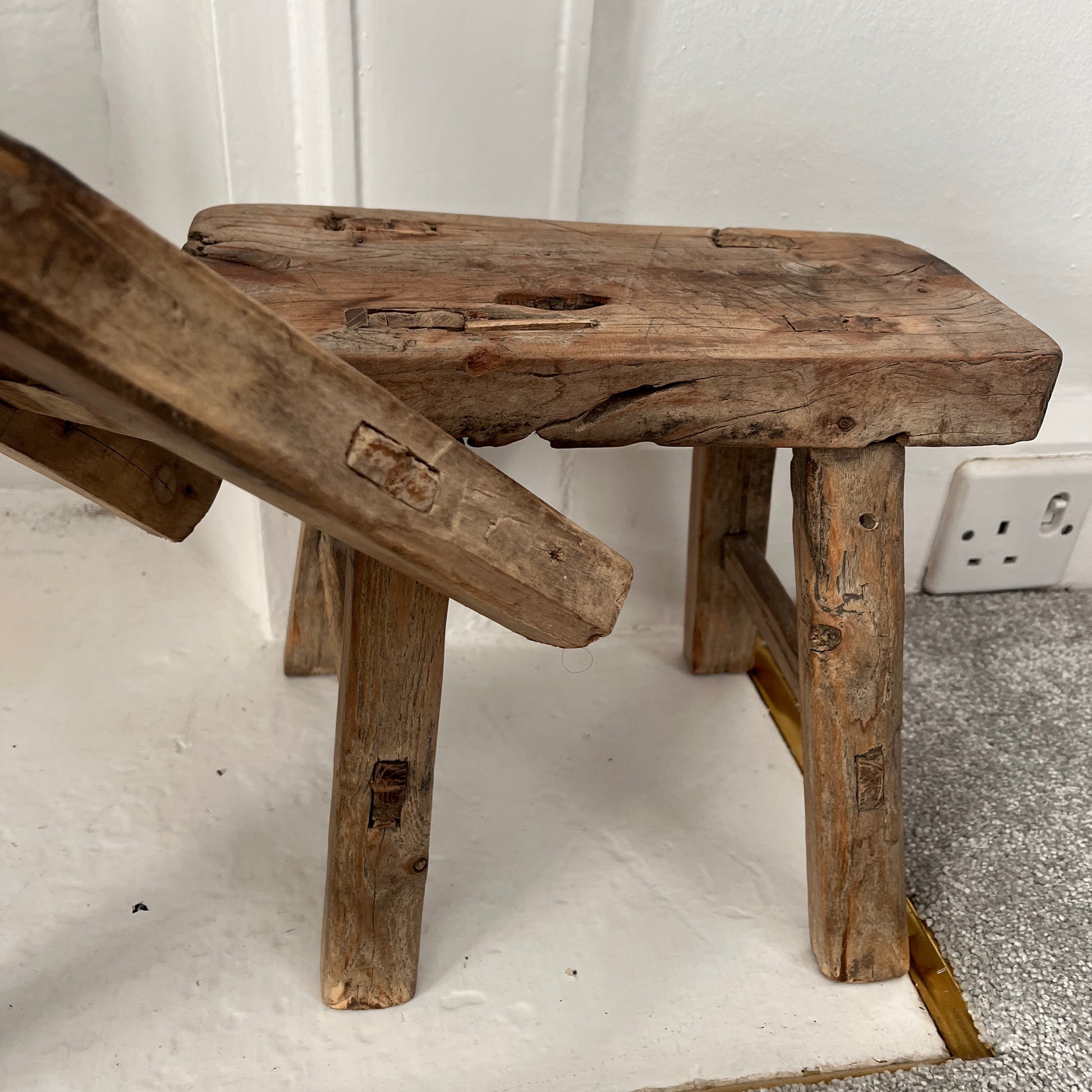 Rustic milking stools with a weathered finish, showcasing simple, sturdy design and vintage countryside charm, perfect for cozy, farmhouse-style decor