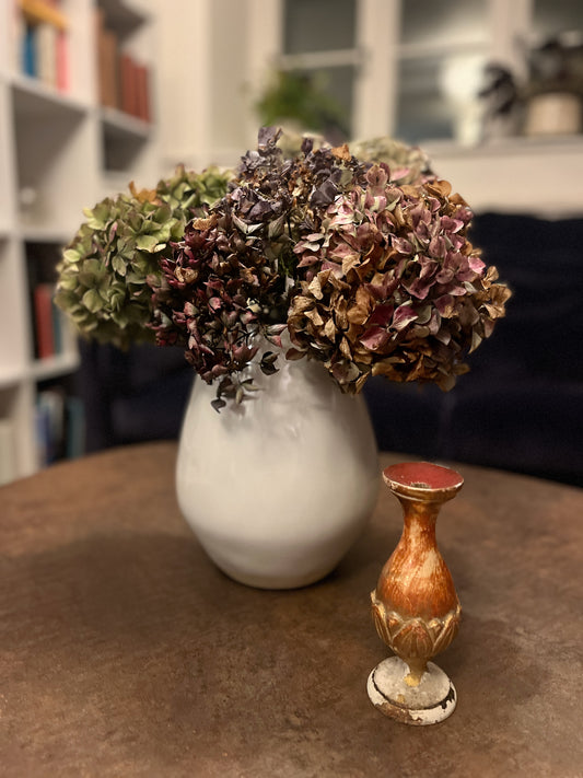 Vintage French candleholder painted red and gold - areas of paint have come off showing the original plaster beneath.