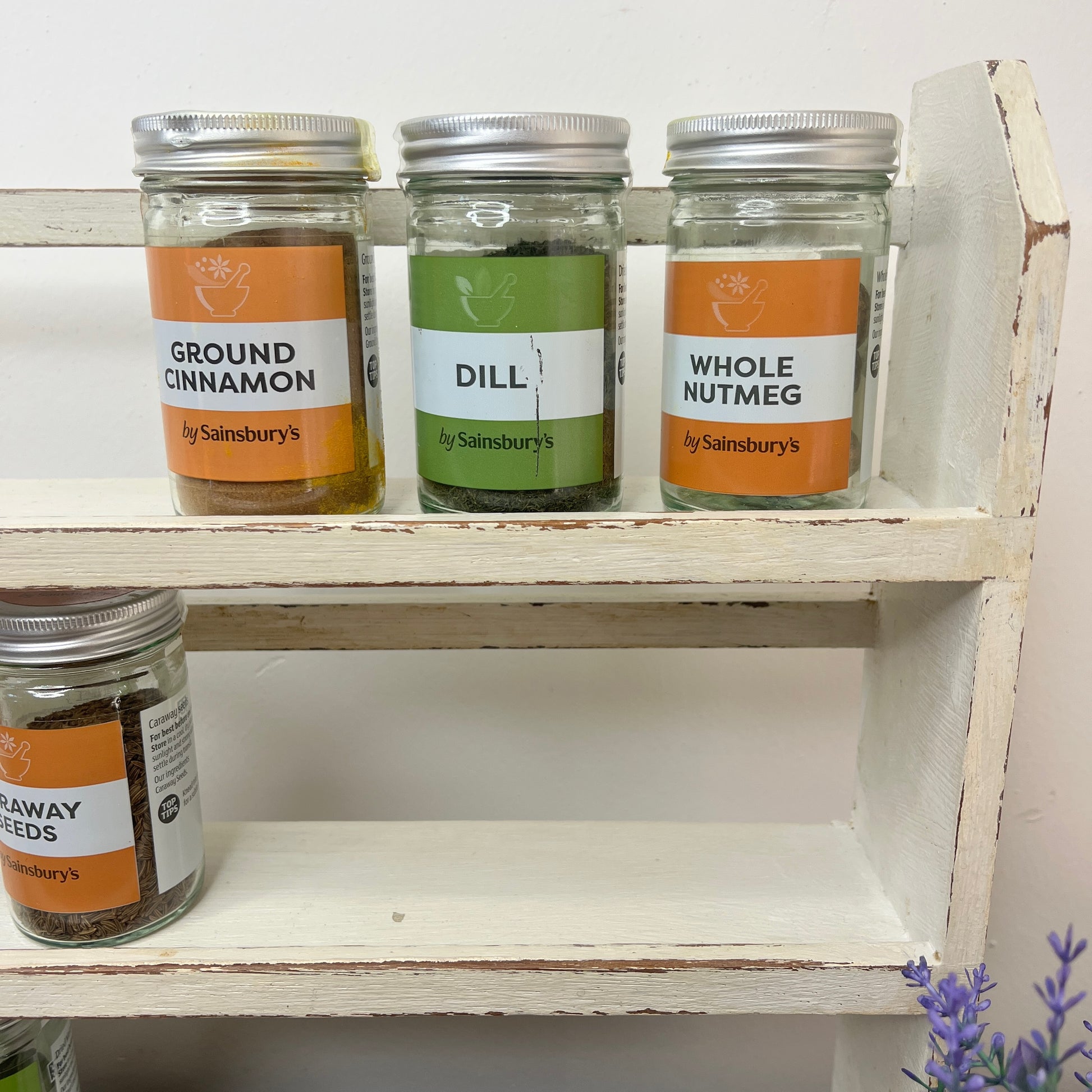 vintage white spice rack with 3 shelves which has become distressed over time