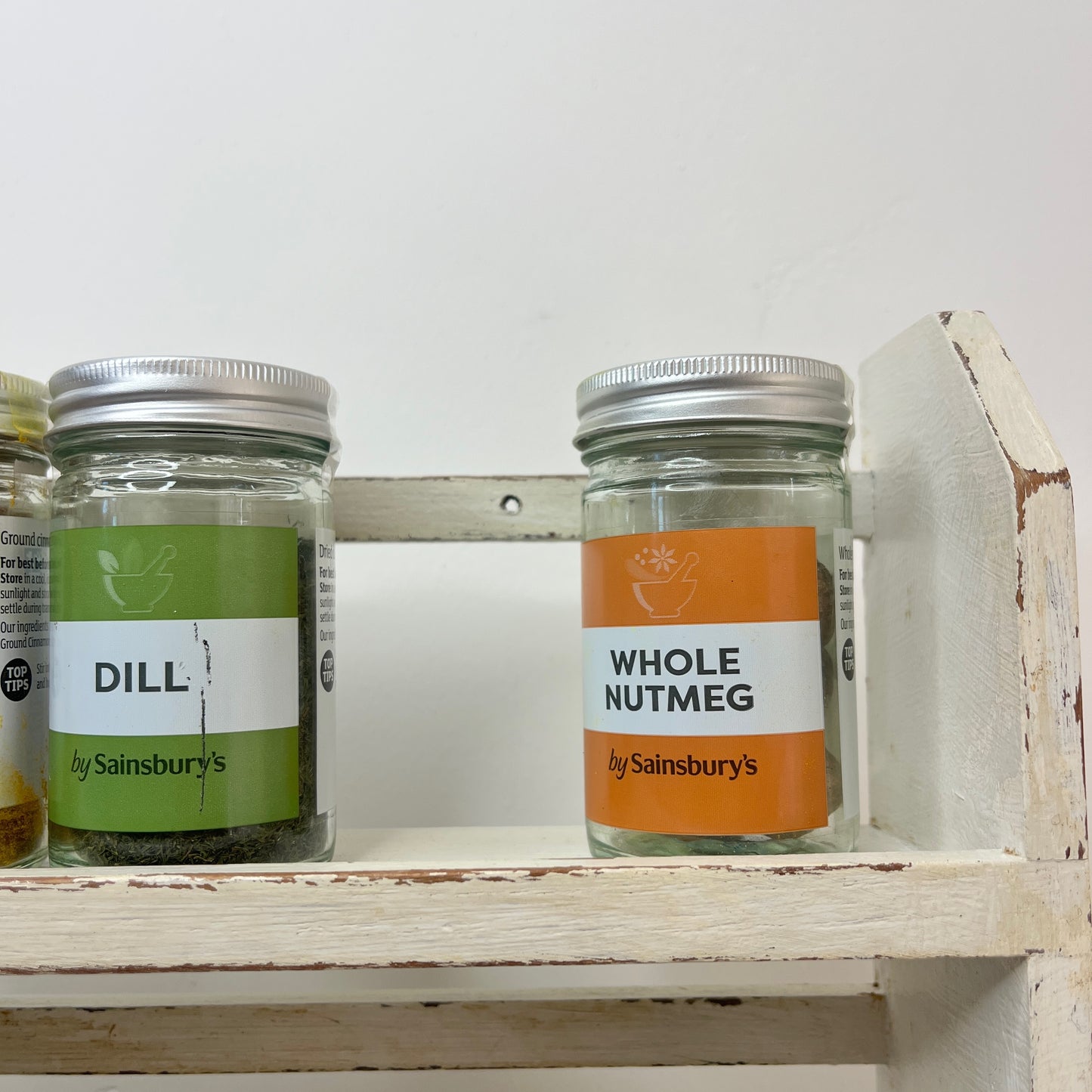 vintage white spice rack with 3 shelves which has become distressed over time